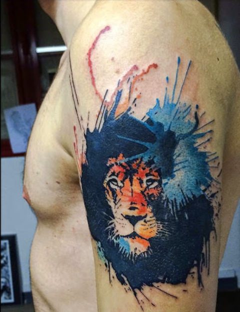 Lion with blue splashes tattoo