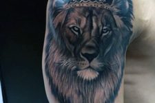 Lion with crown tattoo on the arm and shoulder