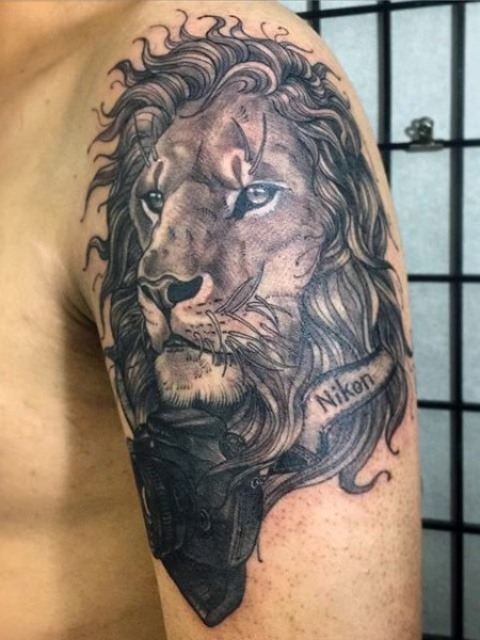 Lion with photo camera tattoo