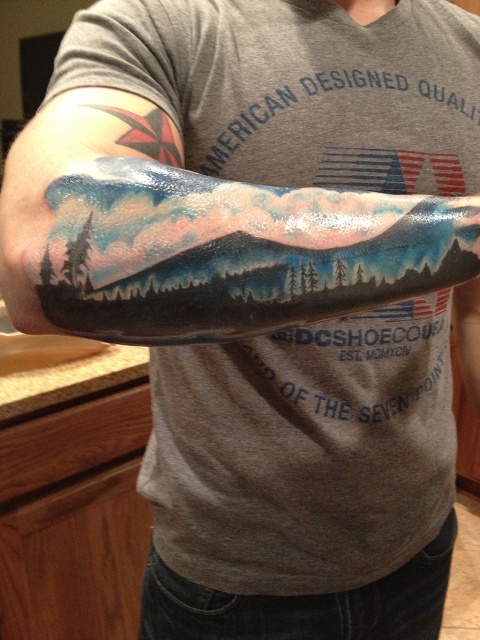 Mountain with clouds and forest tattoo