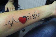 Music heartbeat tattoo on the arm
