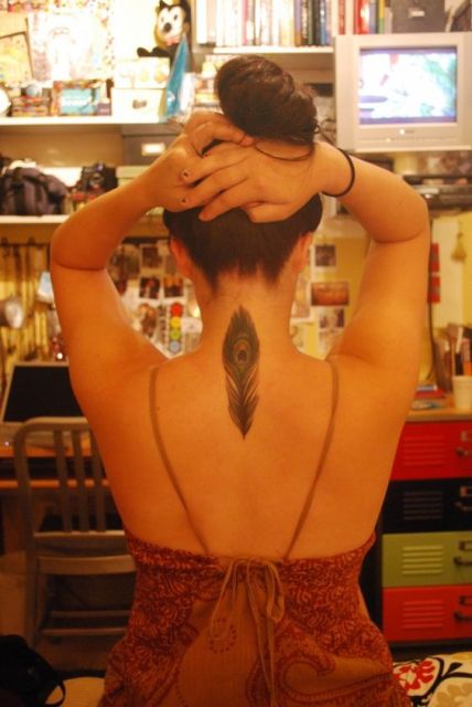Peacock feather tattoo on the back and neck