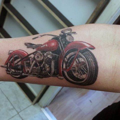 Red bike tattoo on the arm