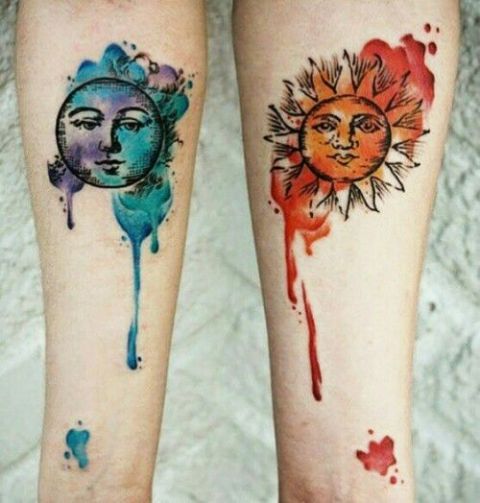 Red sun and blue moon tattoos on the arms