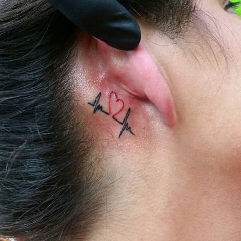 Small black and red tattoo behind the ear