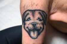 Small dog tattoo on the finger