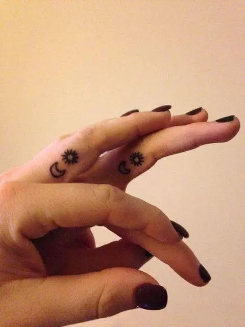 Tiny sun tattoo located on the finger, minimalist