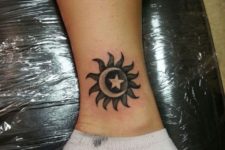 Sun and moon tattoo on the ankle