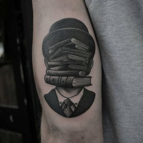 Surreal book tattoo on the arm