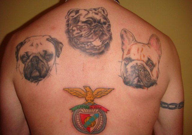 Three dog tattoos on the back