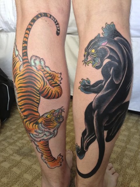 Tiger and panther tattoos on the both legs