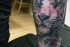 Tiger head tattoo on the forearm