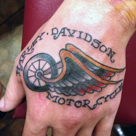 Wheel with wings tattoo on the hand