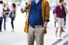 With navy blue shirt, yellow blazer and beige pants