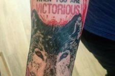 Wolf and quote tattoo on the hand