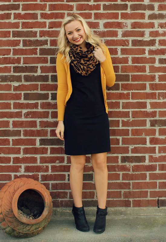 a black dress, a yellow cardigan, black leather booties, a leopard rpint scarf