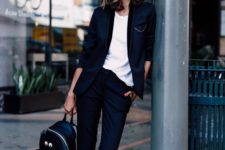 02 a black tuxedo with cropped pants, a white tee, white sneakers and a black backpack
