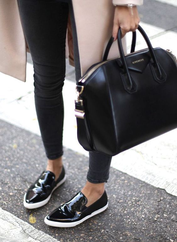 an average size black leather bag is classics that fits many occasions