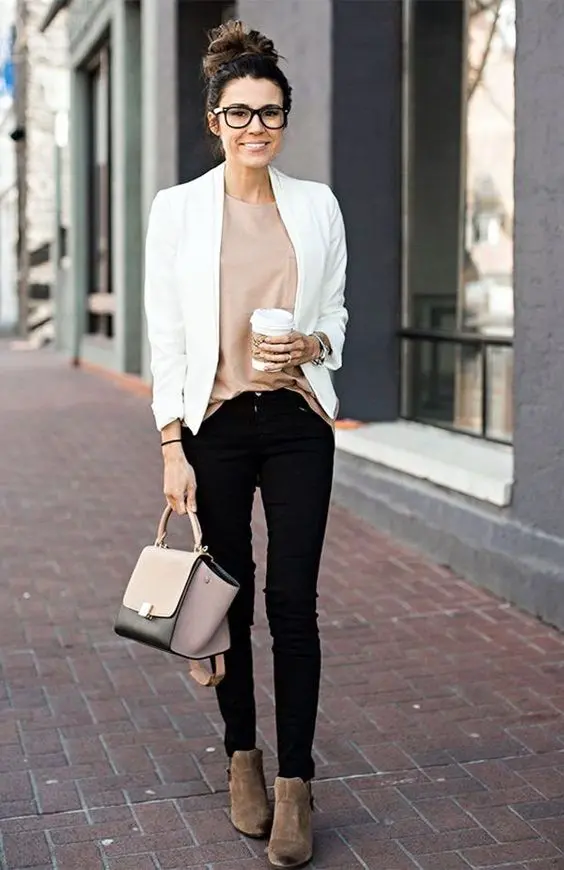 black jeans, a neutral top, brown suede booties, a white blazer and a blush and black bag