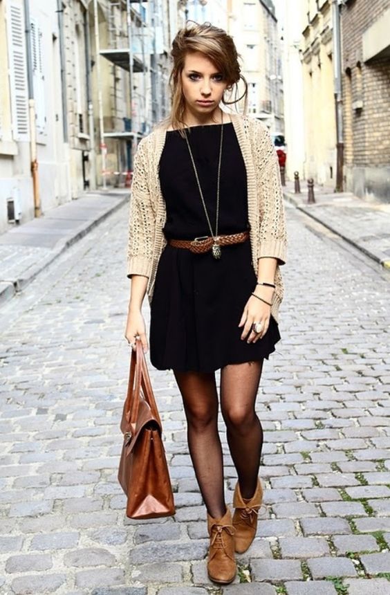 a mini black dress, a neutral cardigan, amber leather booties, a brown leather belt and a matching bag
