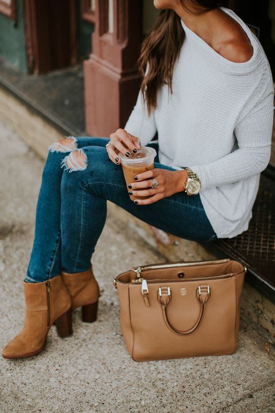 ripped blue skinnies, a white off the shoulder pullover and amber booties