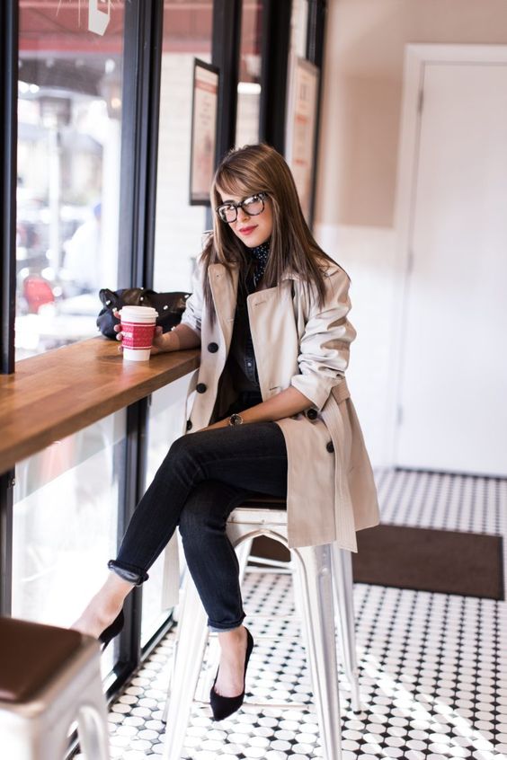 black jeans, black shoes, a creamy trench coat and black buttons for a work look