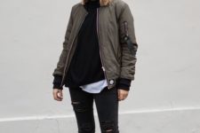 05 ripped black jeans, a black sweater, a white tee, white sneakers and an olve green bomber