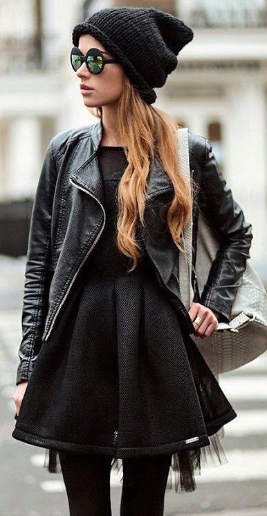 a black dress, black tights, a moto jacket, a beanie and a grey bag