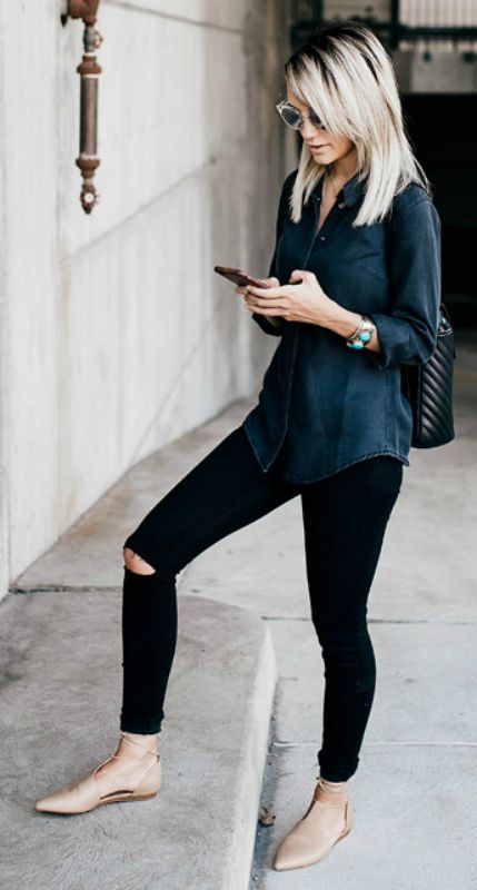 a black chambray shirt, black ripped jeans, nude lace up flats and a black backpack