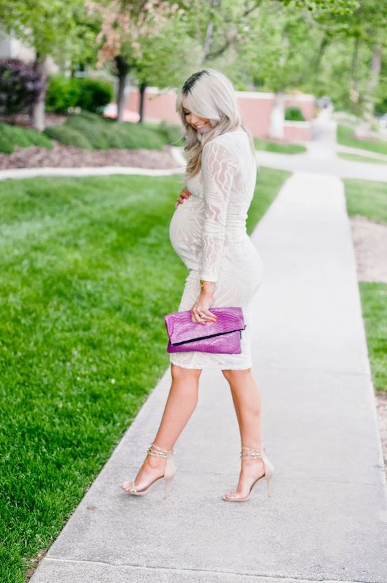 a white lace knee dress with long sleeves, nude heels, a hot pink clutch