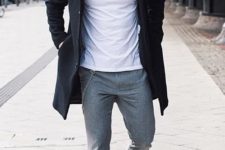 11 a white tee, grey pants, white sneakers and a black coat