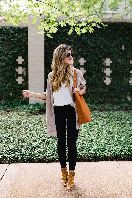 black cropped jeans, a white top, a neutral cardigan, amber shoes and an orange tote