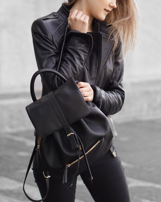 black jeans, a black tee, a black leather jacket and backpack for a rock inspired look
