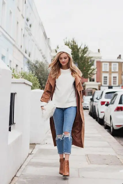 ripped cropped jeans, a white sweater, a camel coat, matching booties and a white beanie