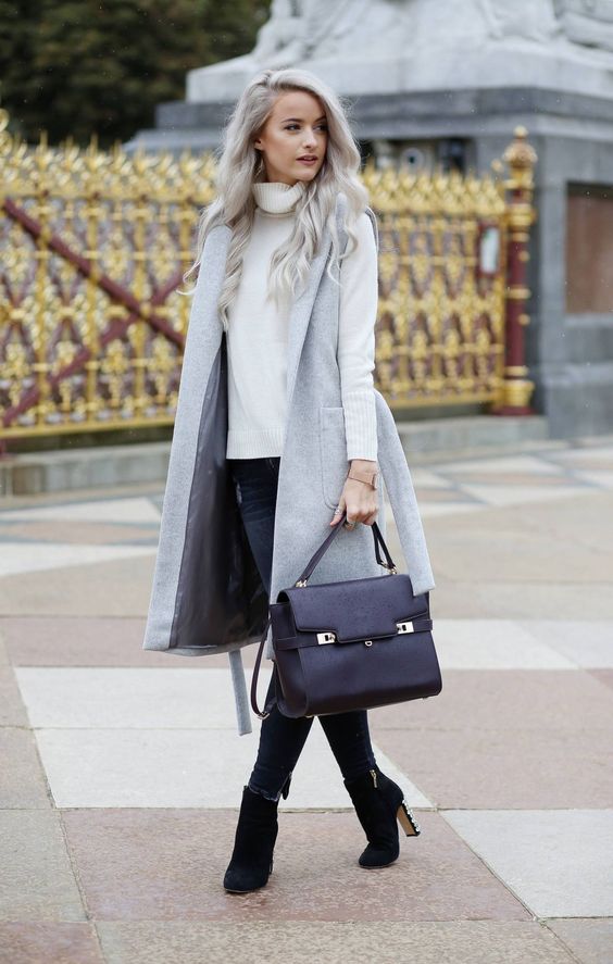 navy skinnies, a white sweater, a grey sleeveless coat, black suede booties and a black bag