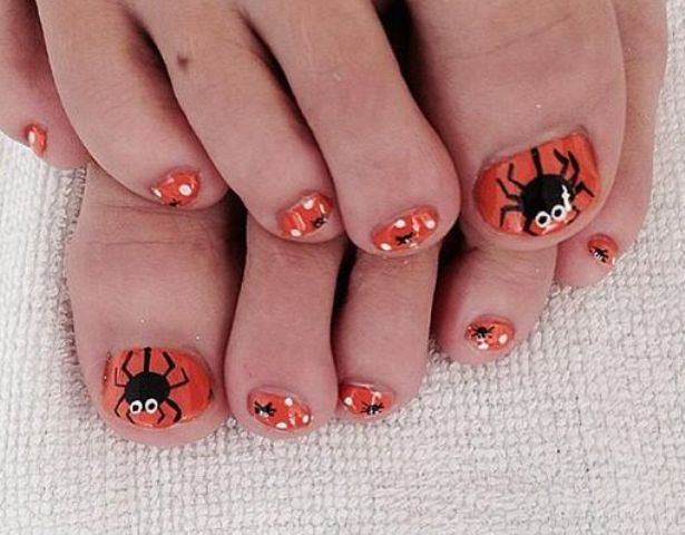 orange toe nails with spiders and polka dots look cut yet Halloween-like