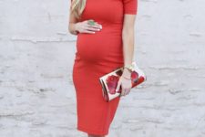 15 a red knee dress with a bow on the shoulder, nude heels and a floral clutch