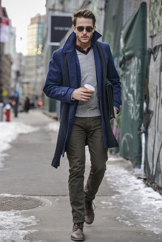 a blue coat, olive green pants, a grey sweater for a chic layered look