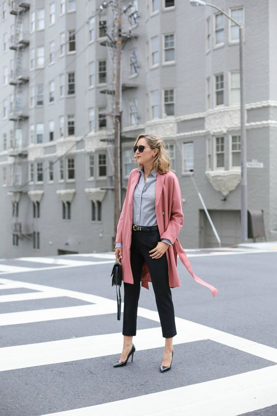 black cropped pants, black shoes, a grey shirt, a pink over the knee coat