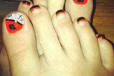 16 striped orange and black nails and accent nails with rhinestones and spiders