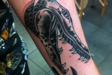 Alligator head tattoo on the forearm