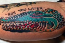 Alligator with message tattoo