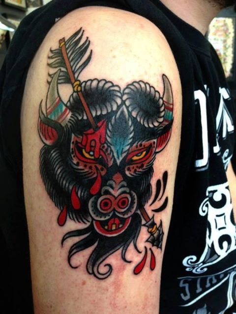 Angry bison and arrow tattoo on the arm