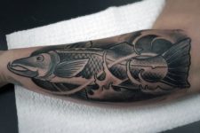 Bass fish tattoo on the forearm