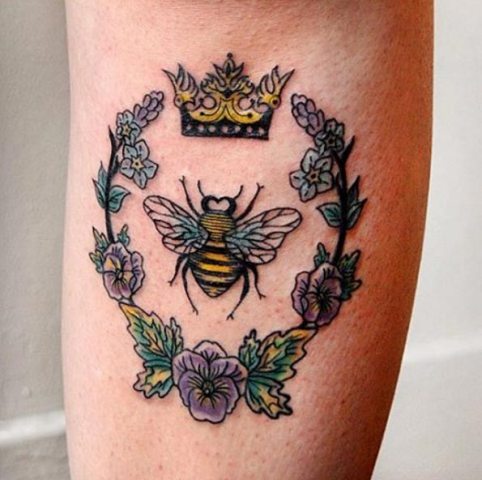 Bee with crown and flowers tattoo on the leg
