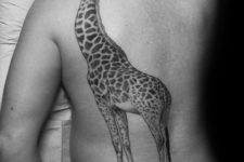 Big giraffe tattoo on the back