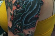 Black and blue panther tattoo on the arm
