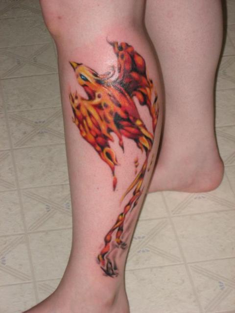 Black and orange colored tattoo on the leg
