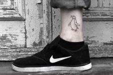 Black-contour tattoo on the ankle