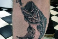 Black fishing tattoo on the leg